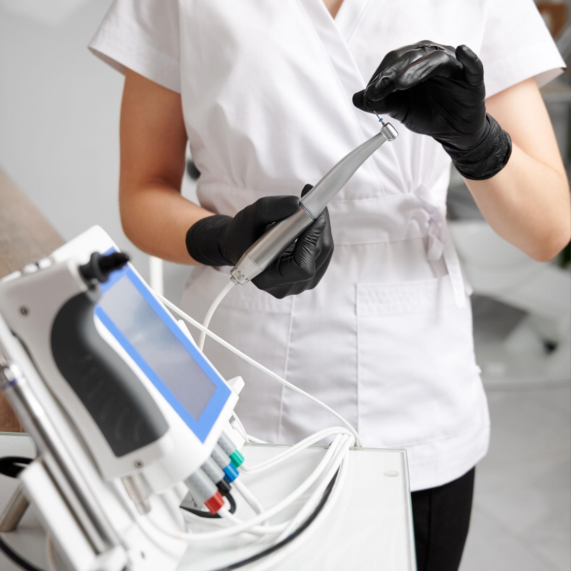 woman cleaning dental equipment