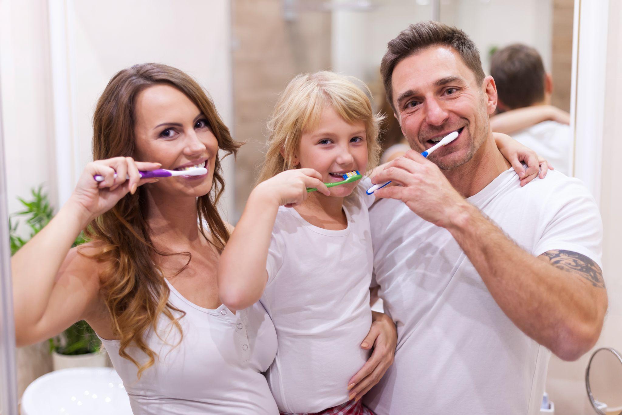 dental floss and oral hygiene with a man in studio on a blue background cleaning his teeth for healthy