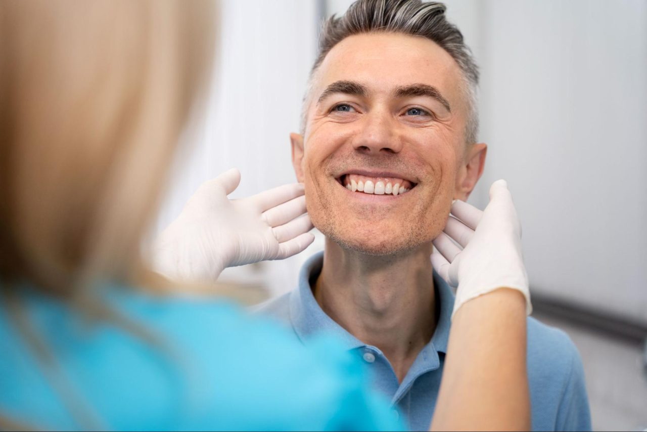 patient with dentist examining smile